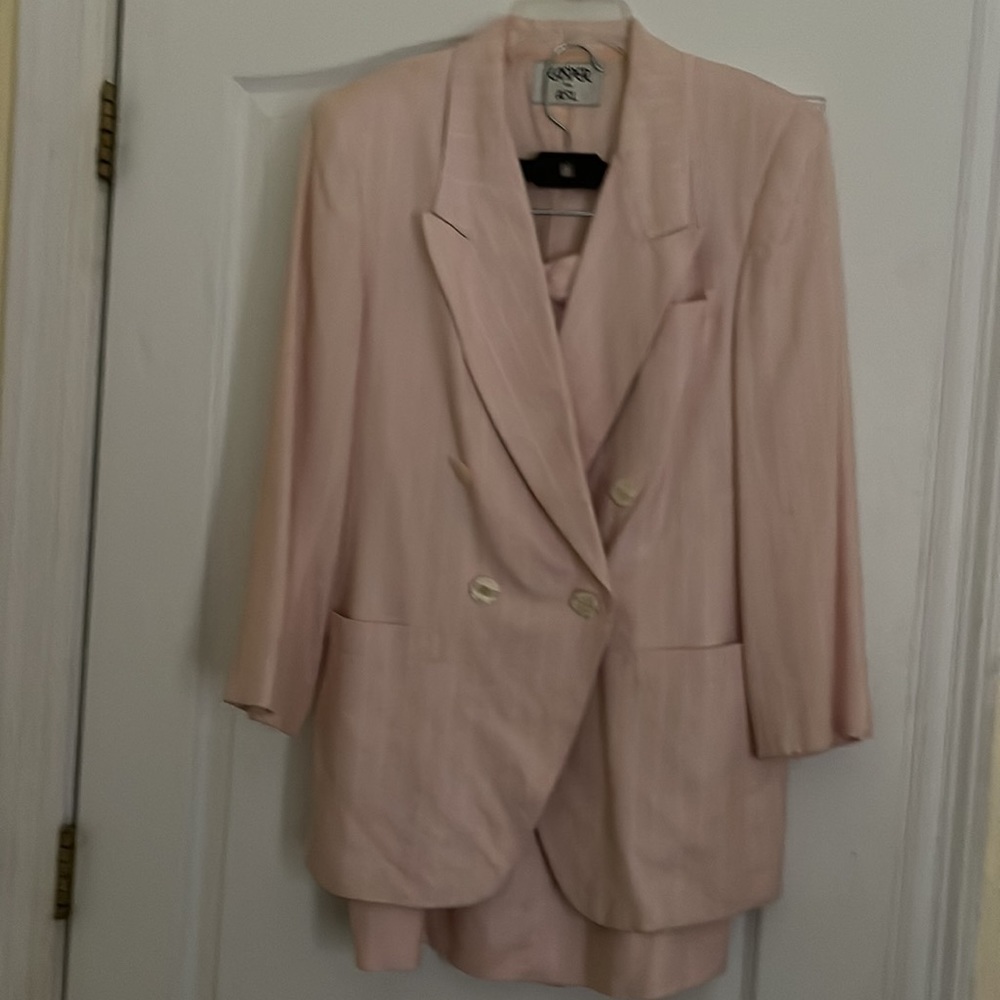Light pink pinstripe suit jacket has three pockets, lined, skirt lined w: pocket